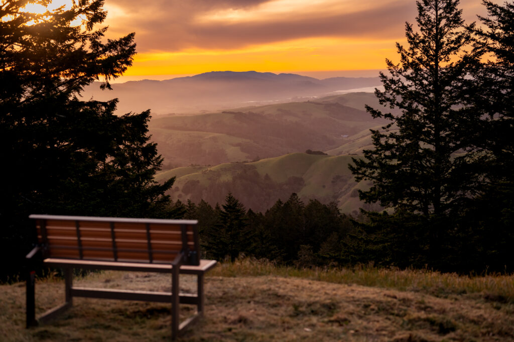 Bench looking west towards the sunset. Inverness ridge, Pacific Ocean, and Tomales Bay are visible. 