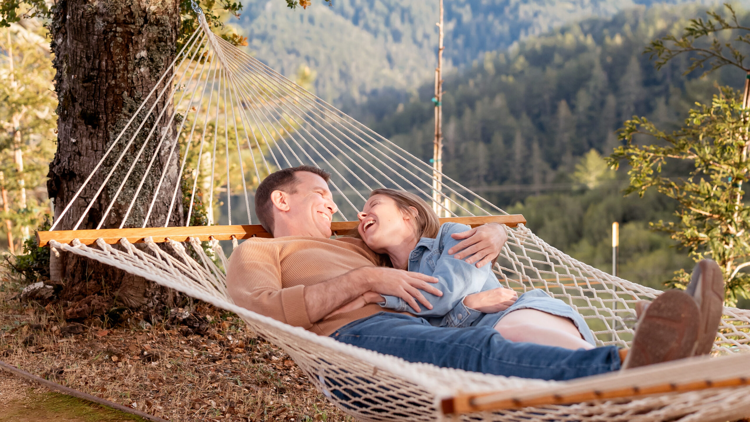 A couple enjoying time on a hammock